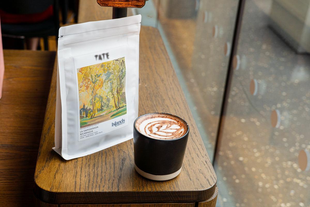 Islands Chocolate x Tate Product with hot chocolate on a wooden table